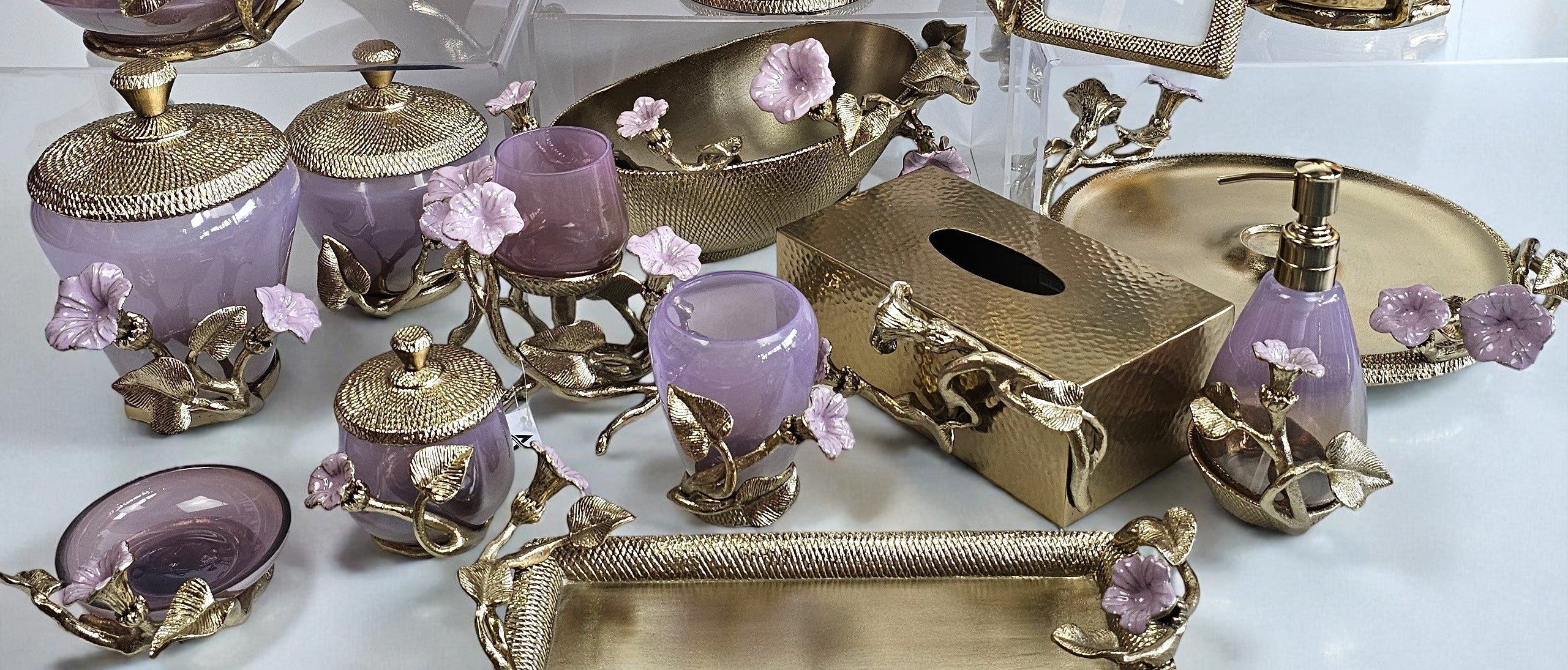 Collection of decorative items with gold and purple accents on a white surface.